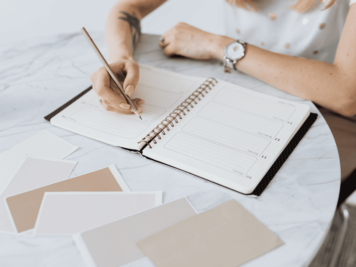 small business owner filling out a social media content planner.